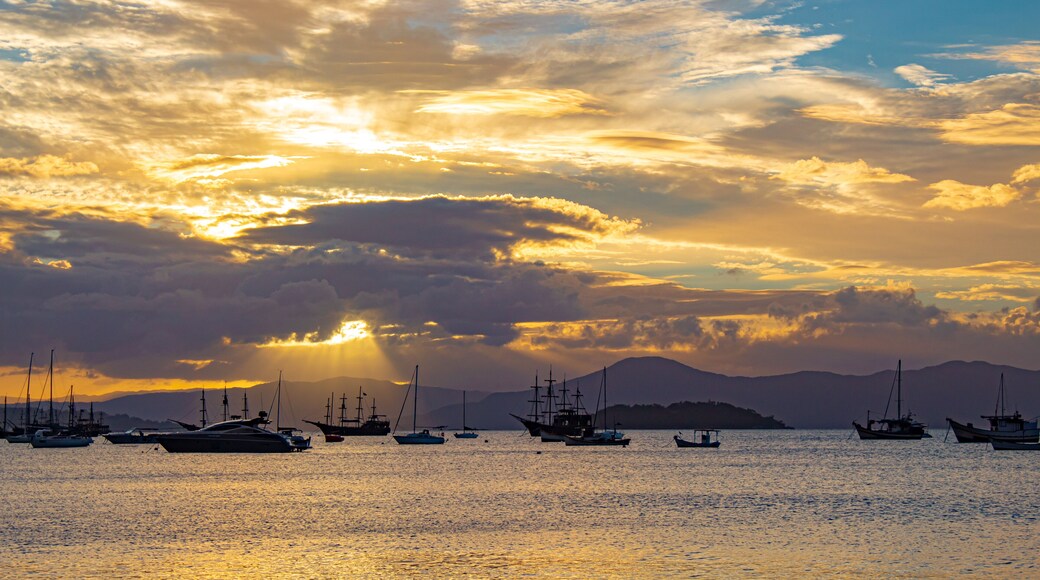 Sunset on a tropical beach with pirate boats in the background located on the beach of Cachoeira do Bom Jesus, Canasvieras, Ponta das Canas, Florianopolis, Santa Catarina, Brazil, Florianópolis