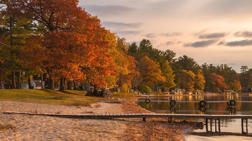 autumn trees beside a lake in Cadillac City in Northern Michigan.