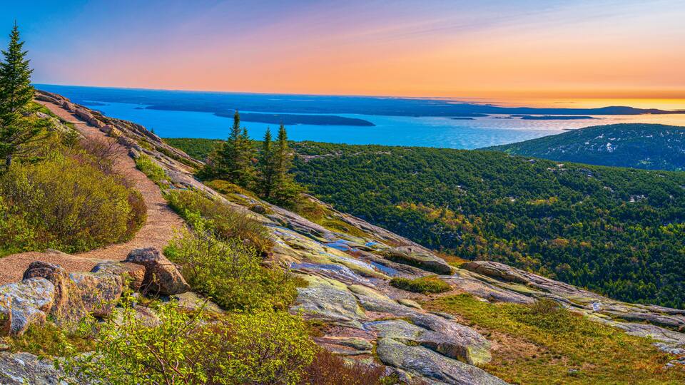 Panorama of the Cadillac Mountain Overlook in Acadia National Park, Bar Harbor, Maine, beautiful expansive vista over glacial rocks at sunrise