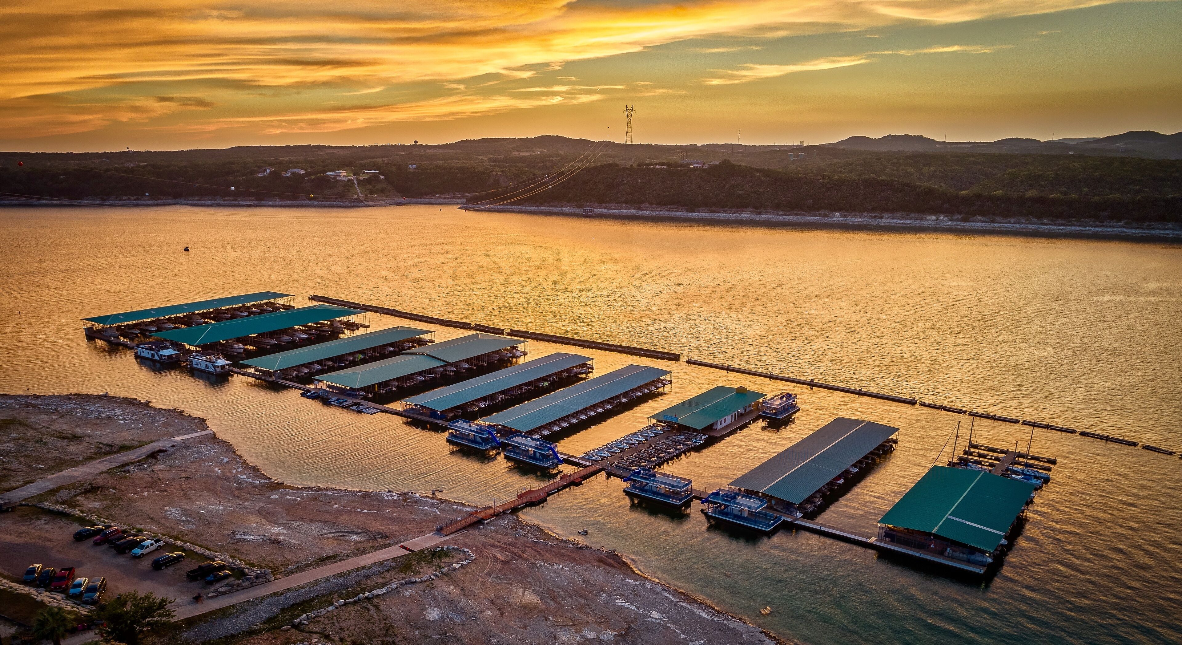 A large body of water with a dock and boats.