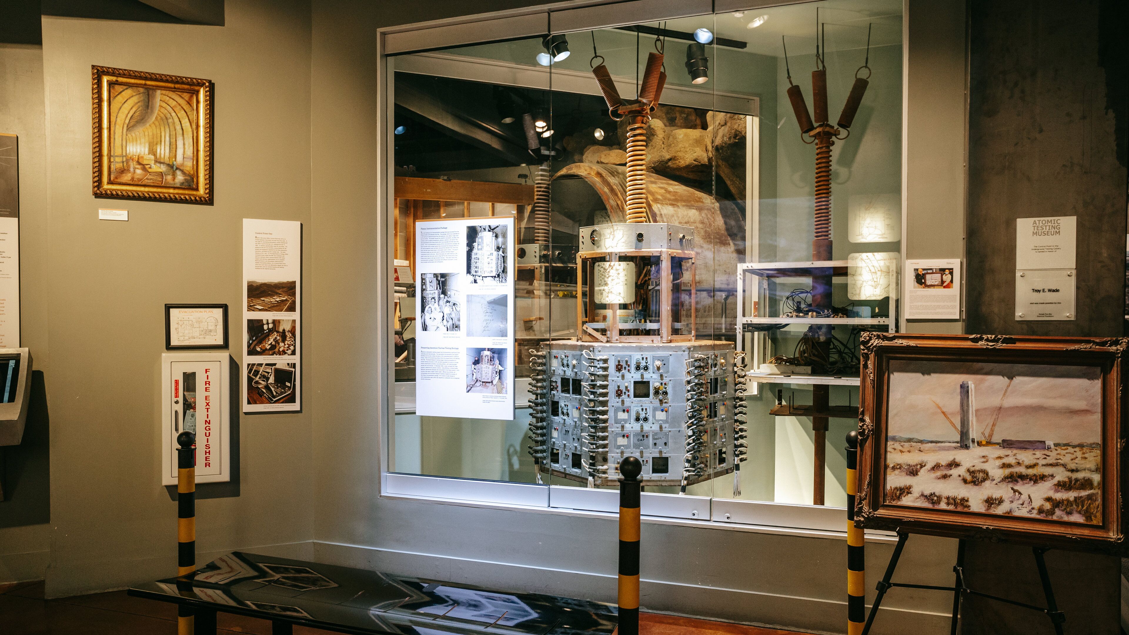 An exhibition with scientific equipment, framed artwork, and informational panels.