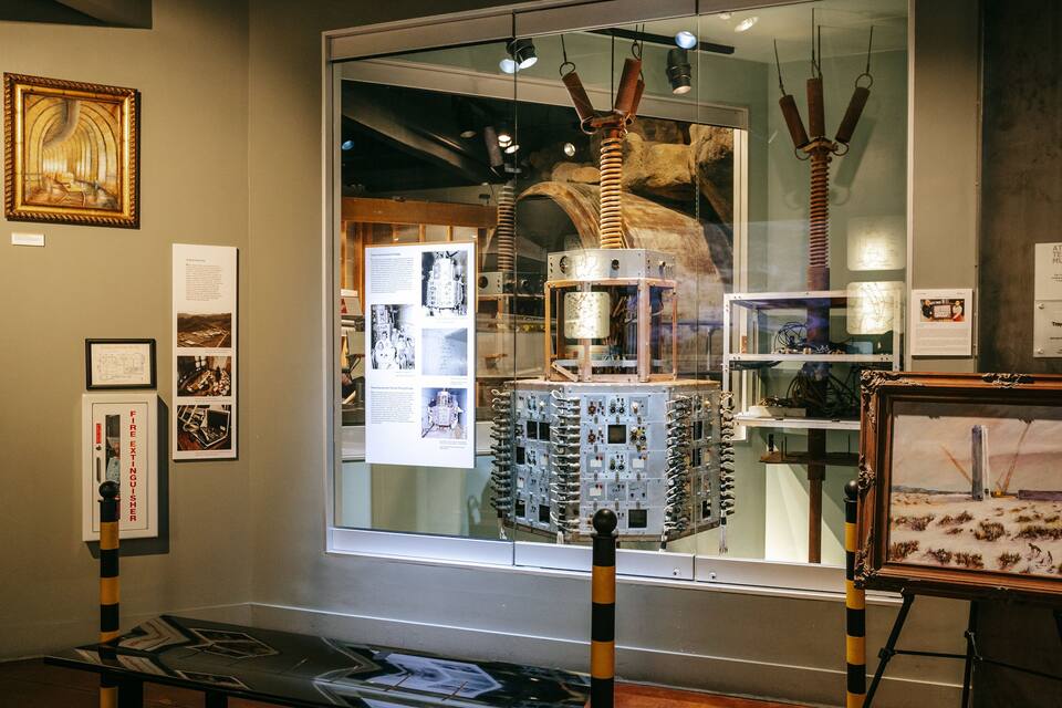 An exhibition with scientific equipment, framed artwork, and informational panels.