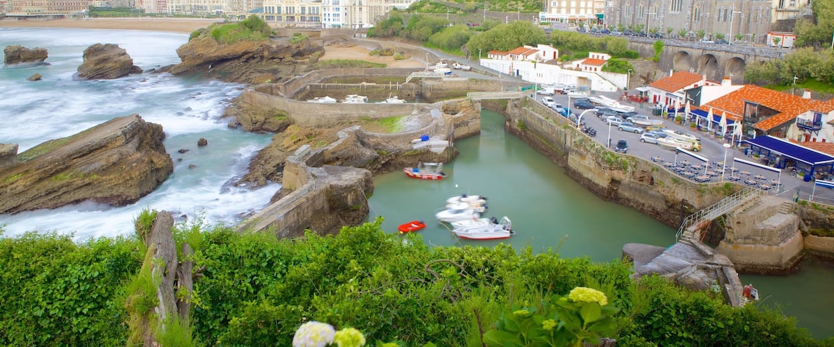 Old Harbor featuring rocky coastline and a coastal town