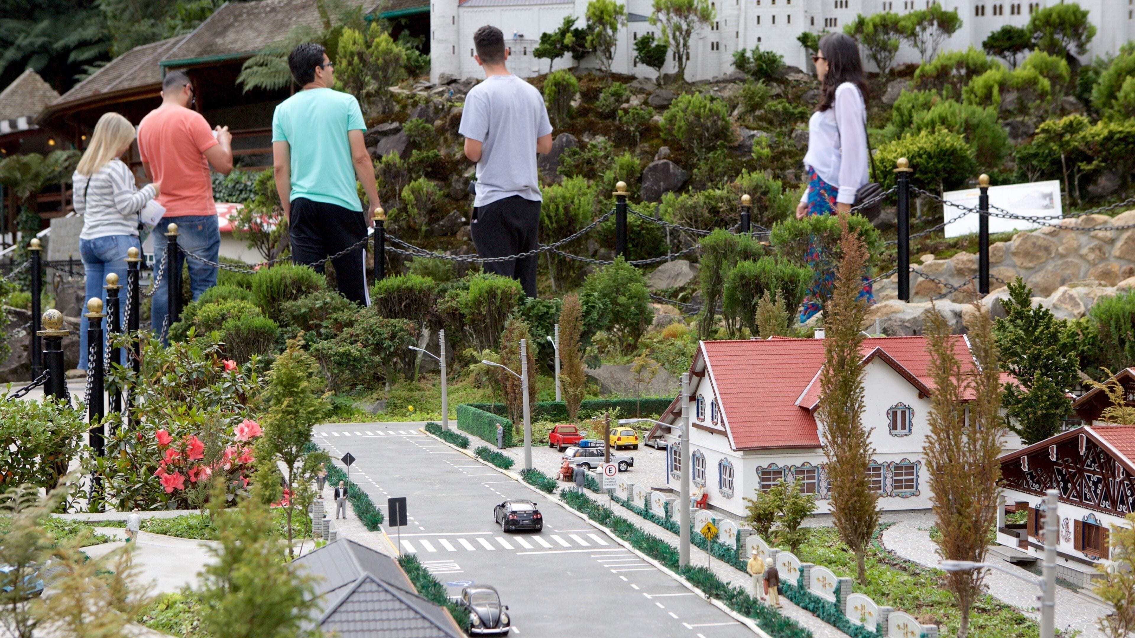 A model town with miniature cars, houses, and people.