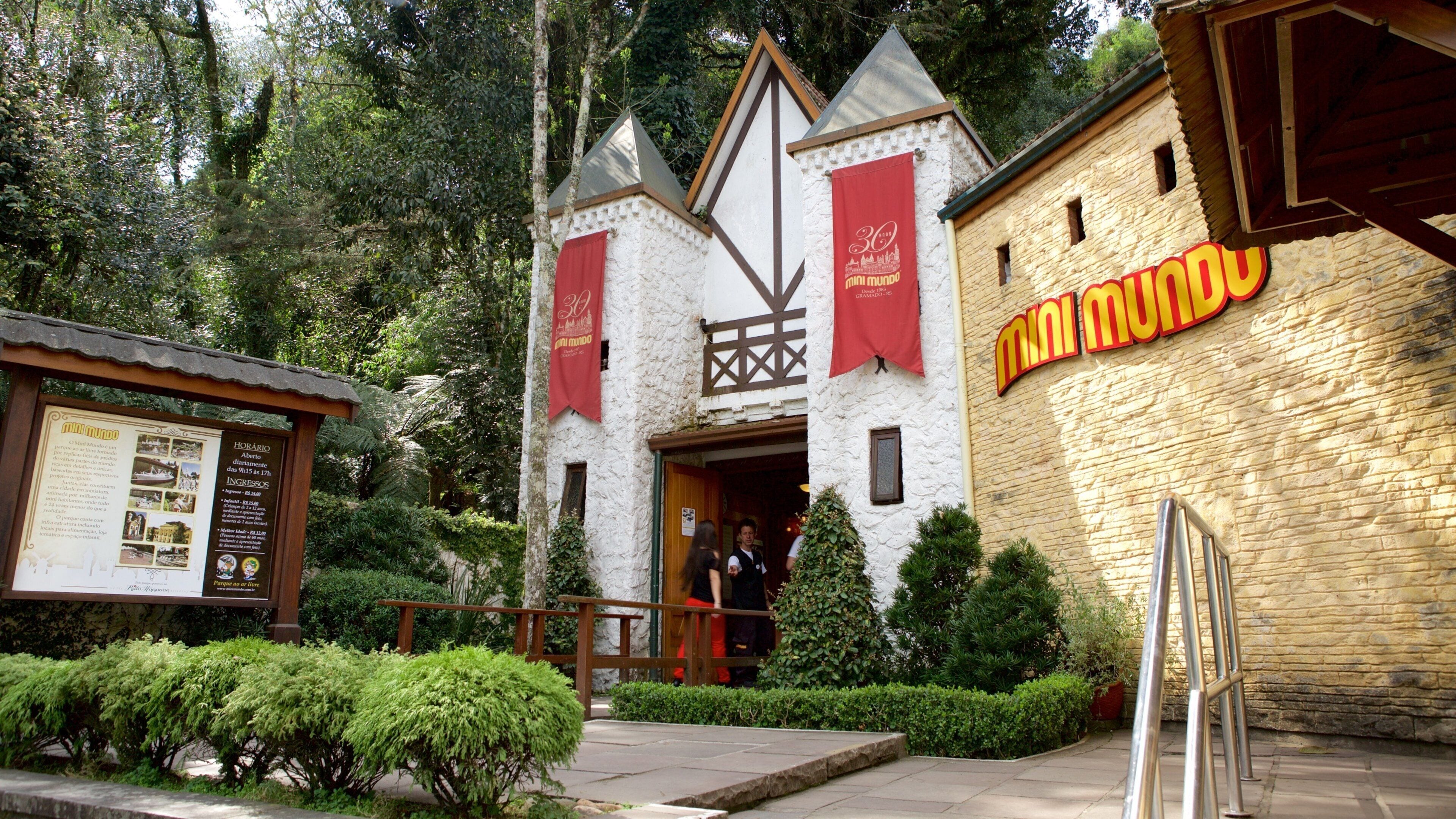 A castle-like building with a sign reading "mini mundo" and a red banner.