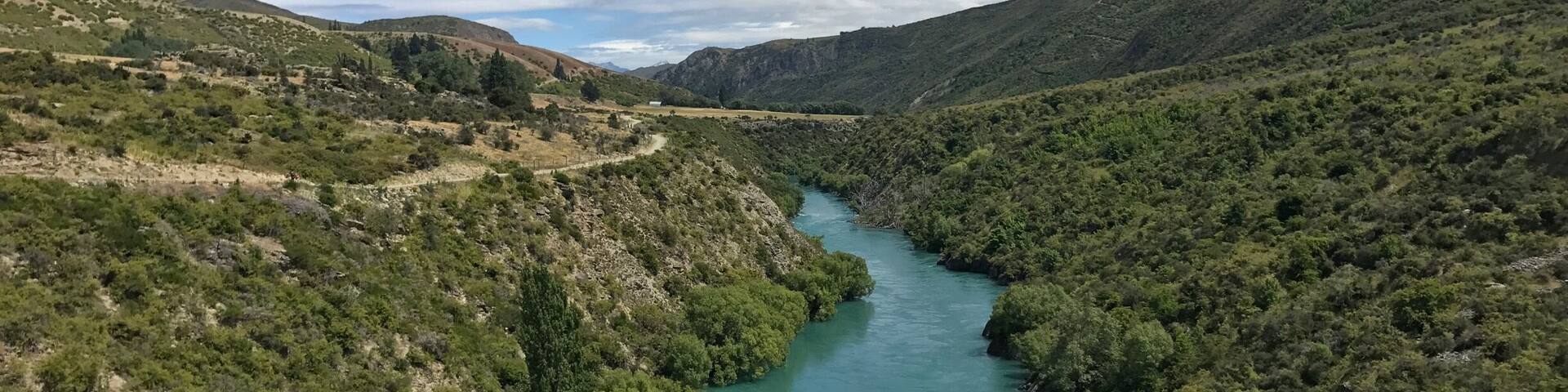 A river winding through a mountainous landscape with dense green vegetation.