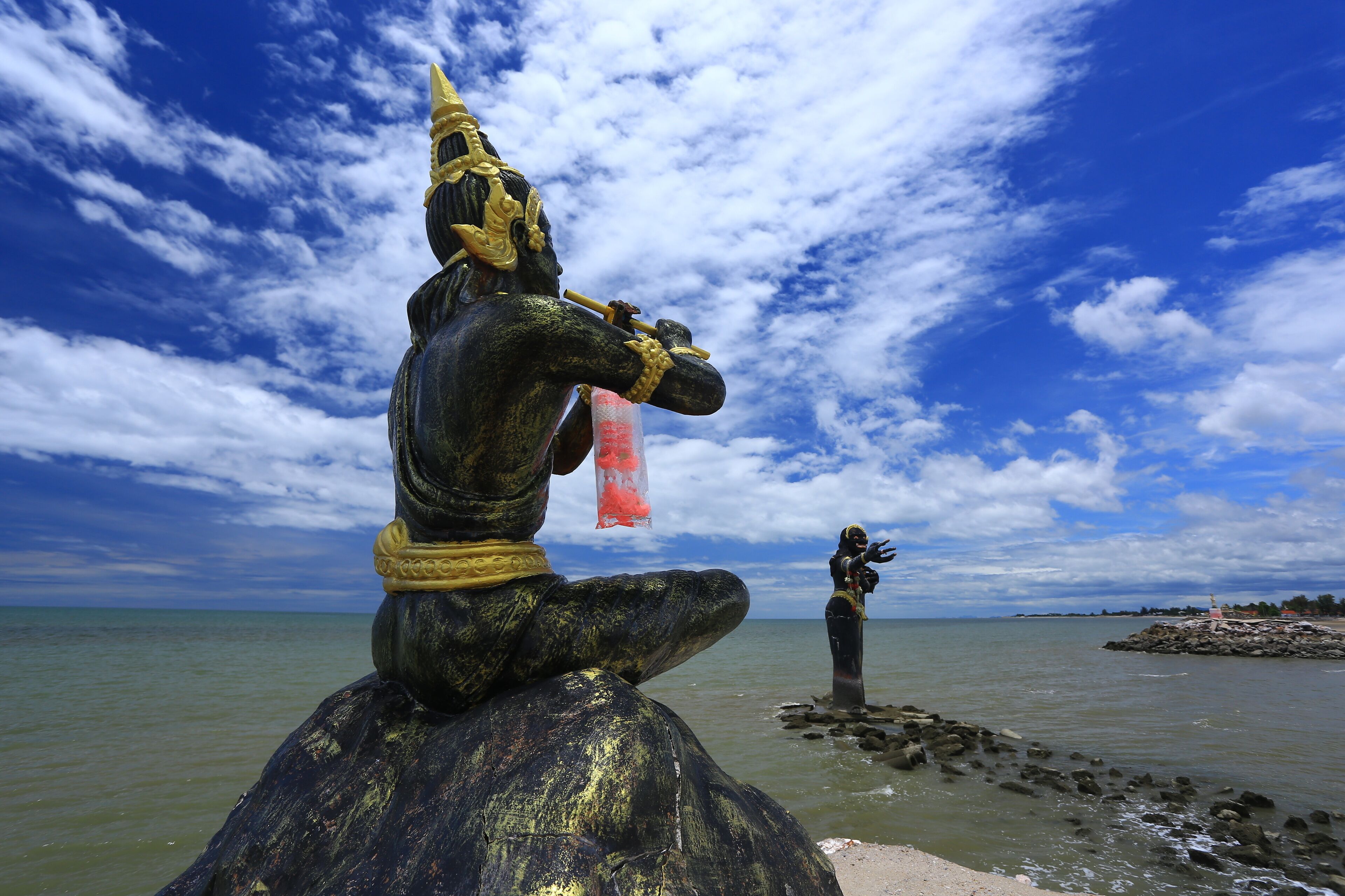 Scary giant black statue in the sea Puek Tian beach Phetchaburi Province, Thailand 