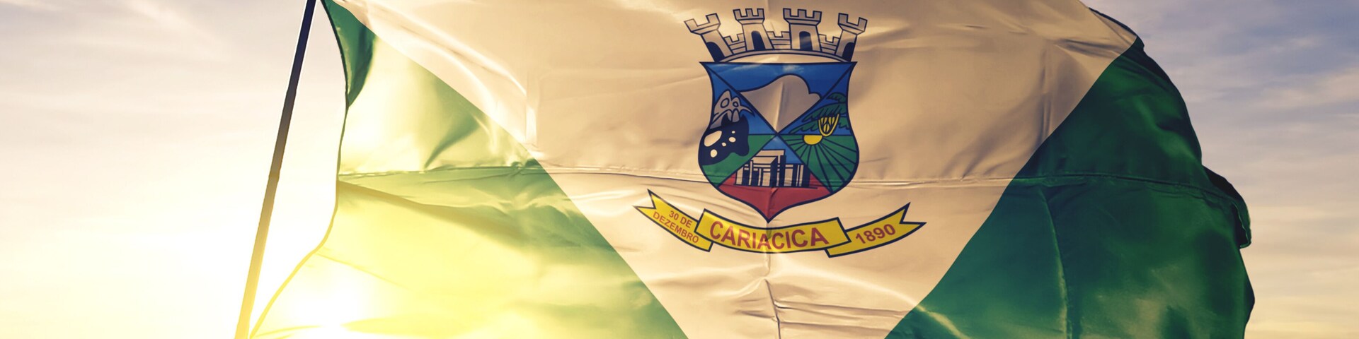 Cariacica of Brazil flag waving on the top sunrise mist fog