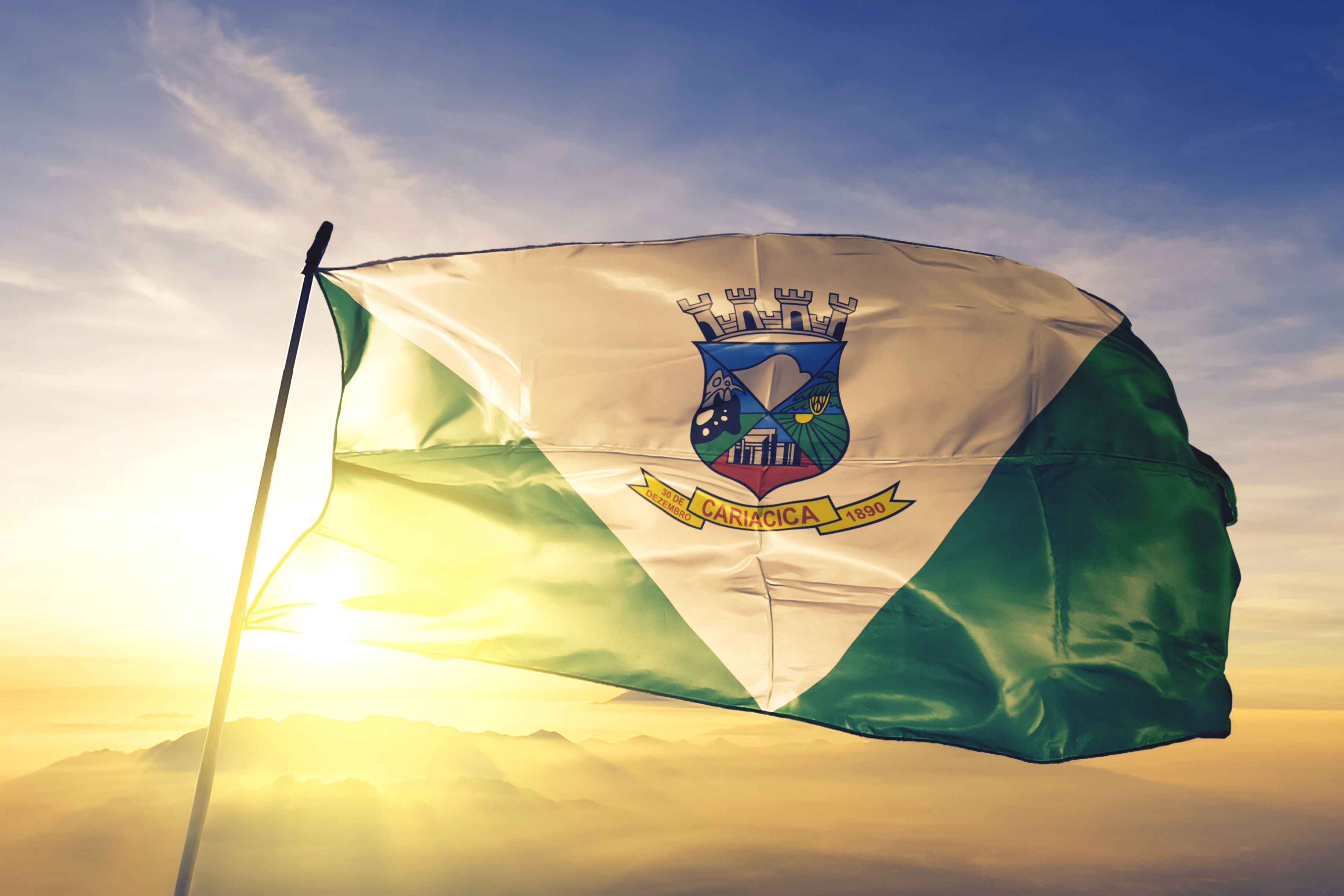 Cariacica of Brazil flag waving on the top sunrise mist fog