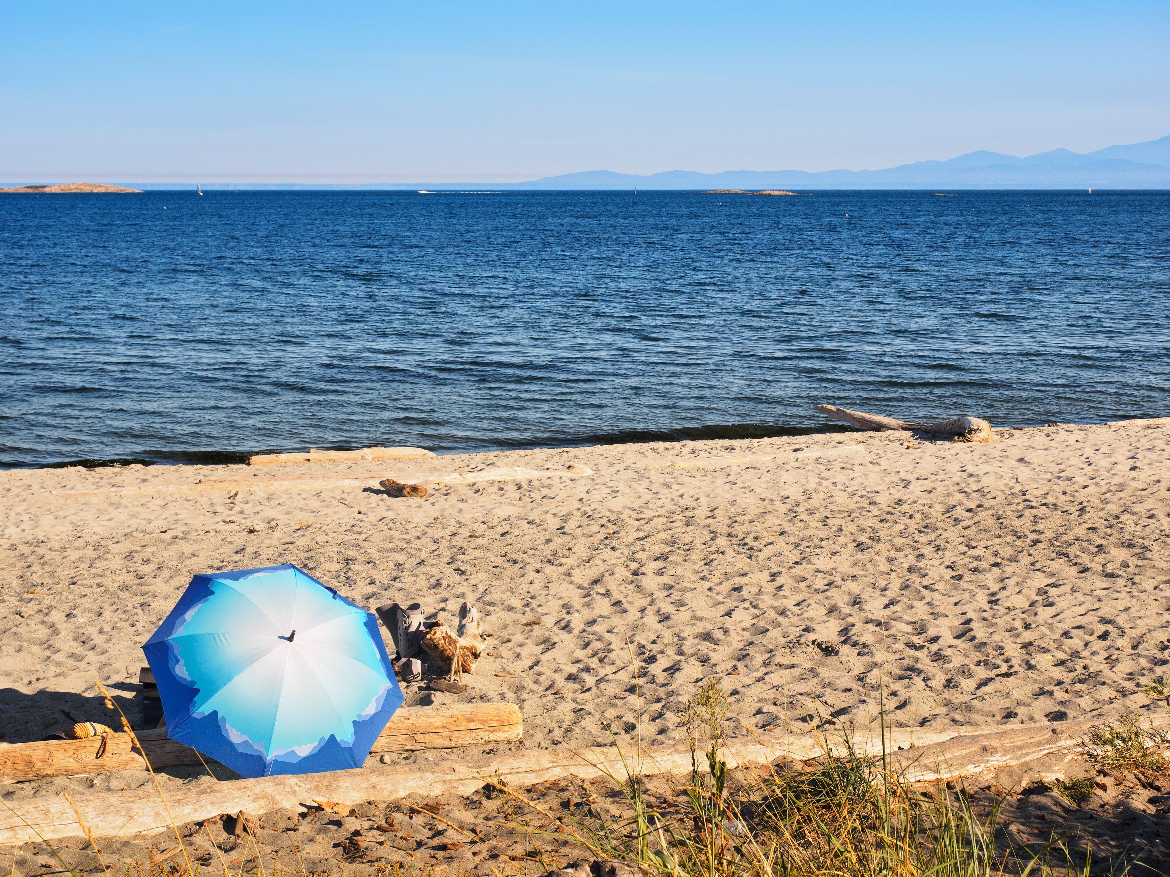Umbrella on a sandy Willows beach, Victoria BC