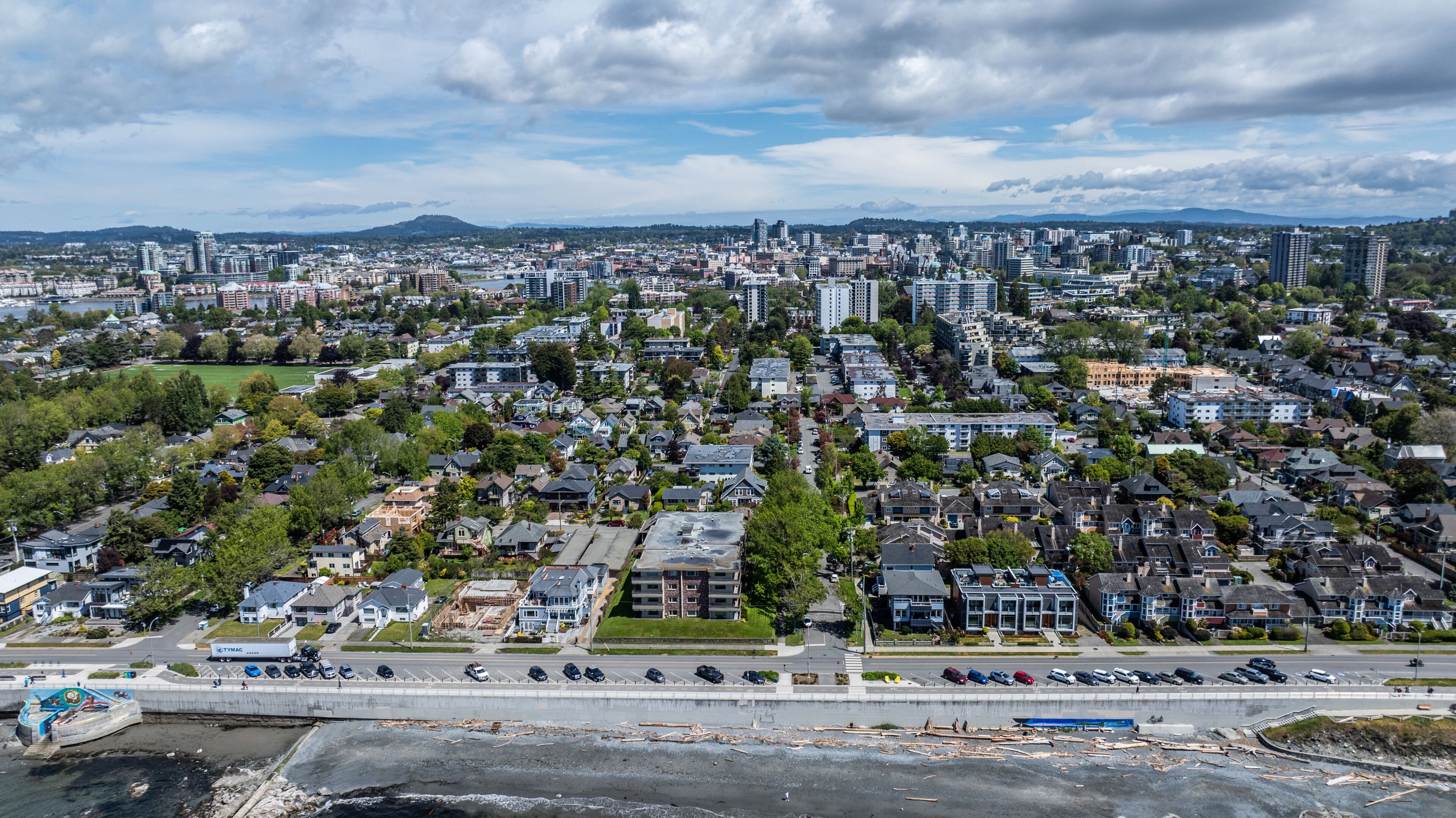 aerial cityscape view of Victoria, the capital of British Columbia, from Dallas Rd at Salish Sea, across James Bay district in front,  Downtown, Burnside and Victoria West in background 