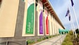 A building with banners advertising a coin shop.