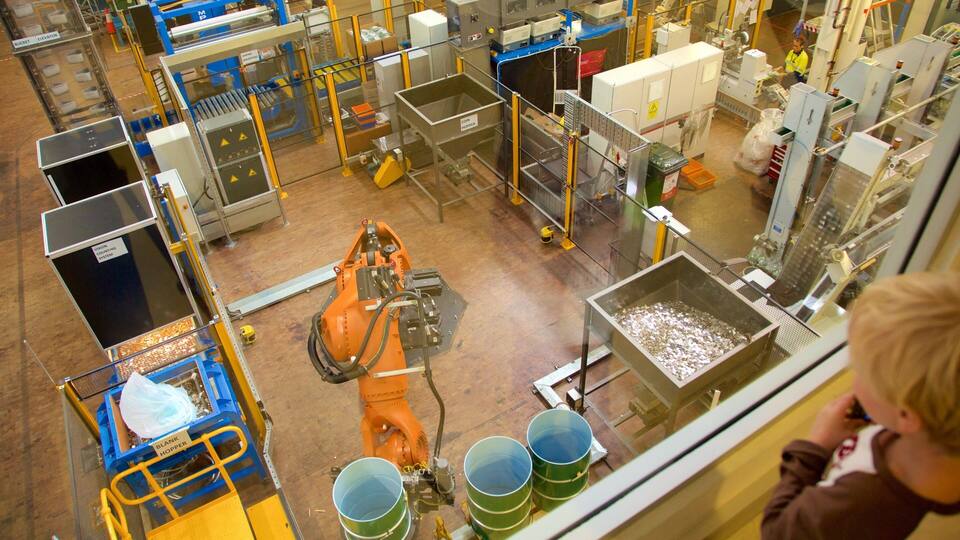 A coin sorting facility with machinery, bins, and a worker.