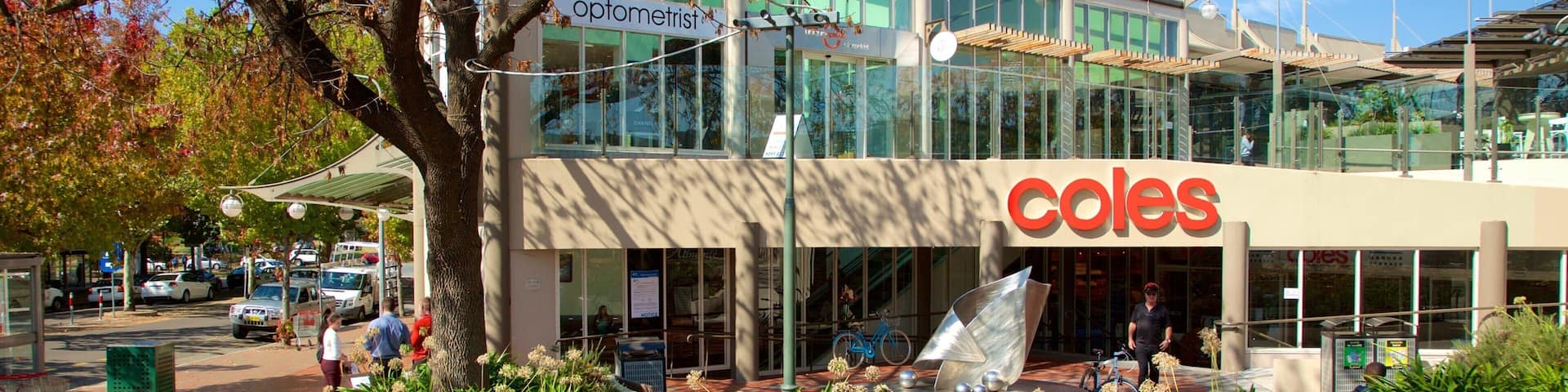 Manuka Shopping Centre which includes autumn leaves and signage