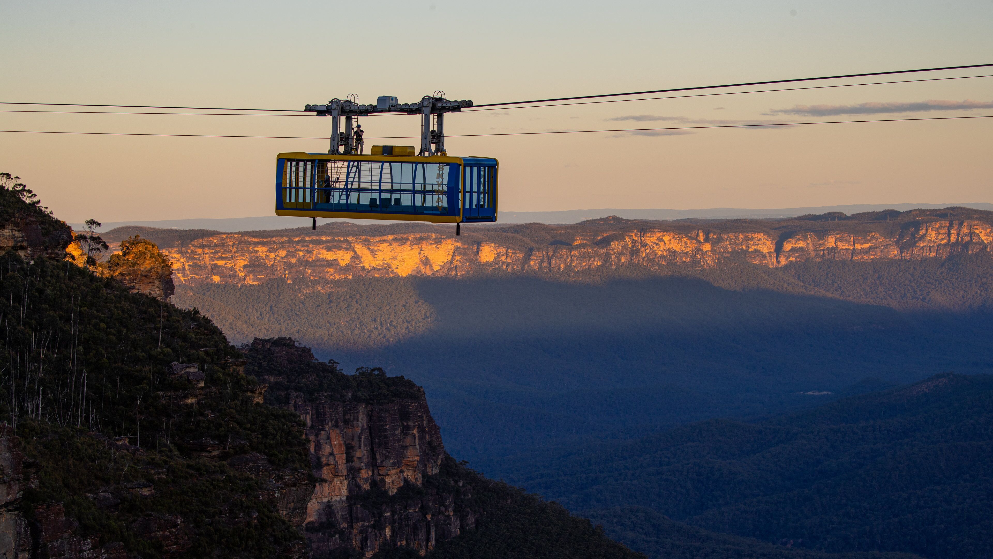 Katoomba Scenic World showing a gondola, a sunset and a gorge or canyon