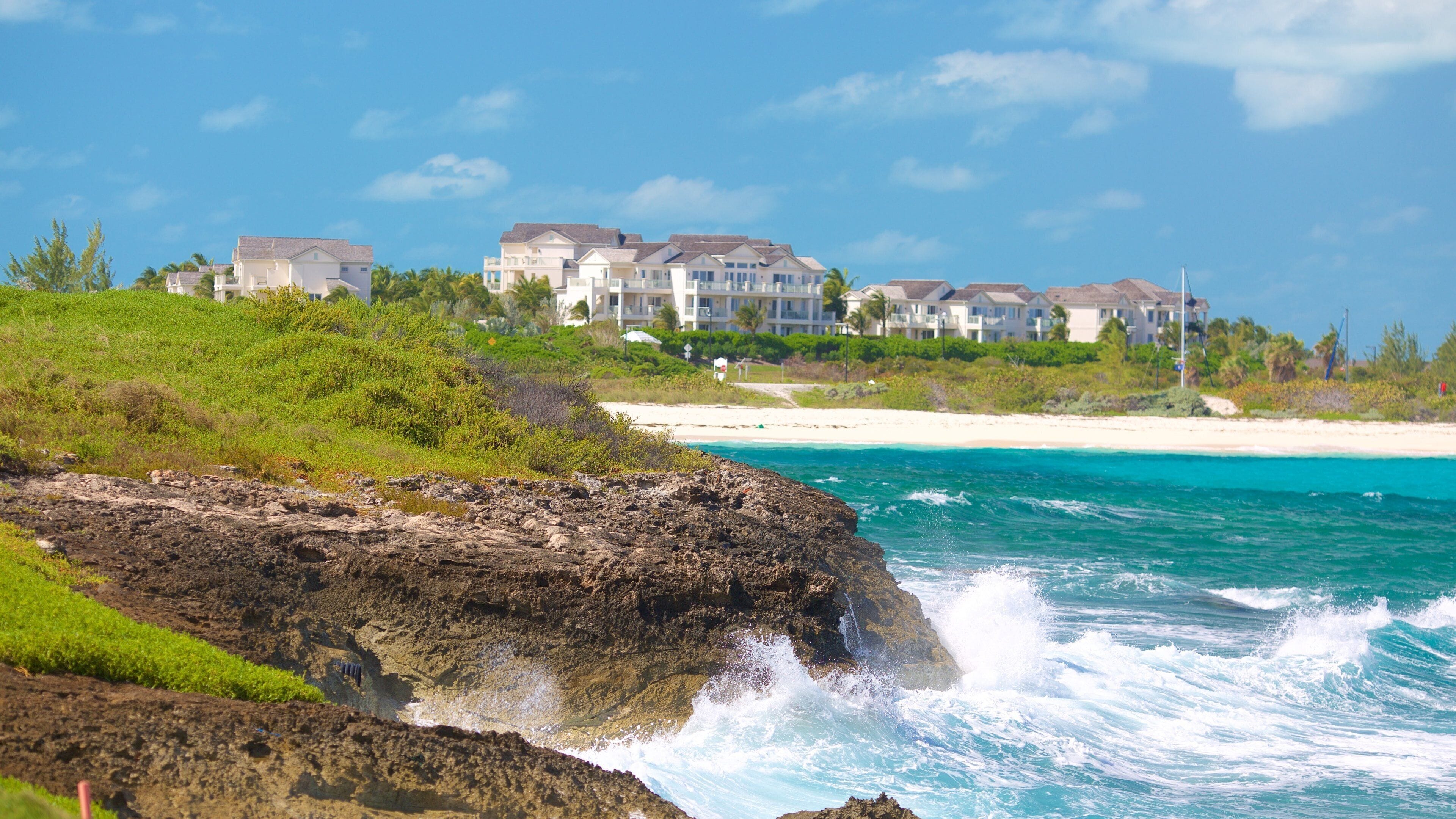 Emerald Bay showing surf, rocky coastline and a beach