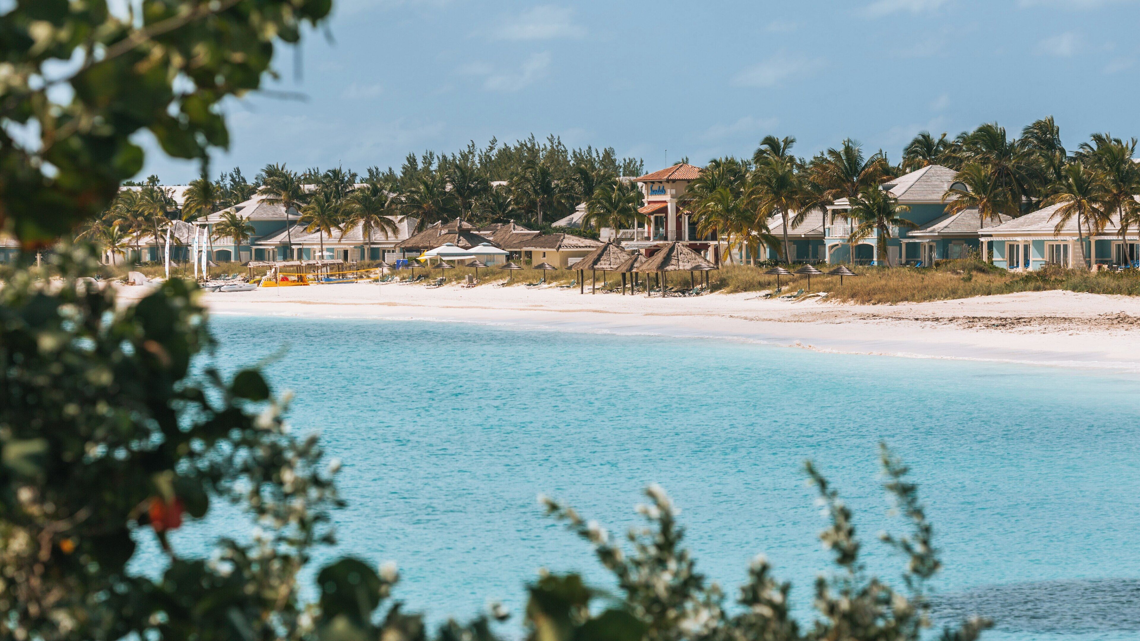 Emerald Bay Beach offers serene beauty and tranquil waters at Rokers Point in Exuma, Bahamas during a sunny day