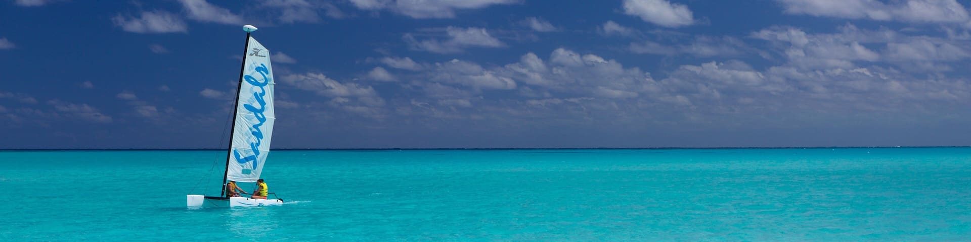 Emerald Bay showing tropical scenes, sailing and a beach