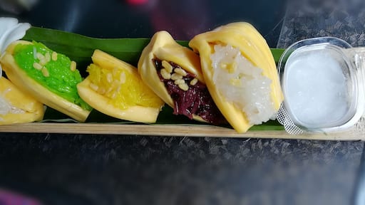 Jackfruit stuffed with glutinous rice sided with coconut milk served in a bamboo tube. This is a traditional and unique dessert in Thailand. This floating market has many local food. There are a lot of seats near the water, so you can enjoy the view of waterfall while eating. #GoodEats