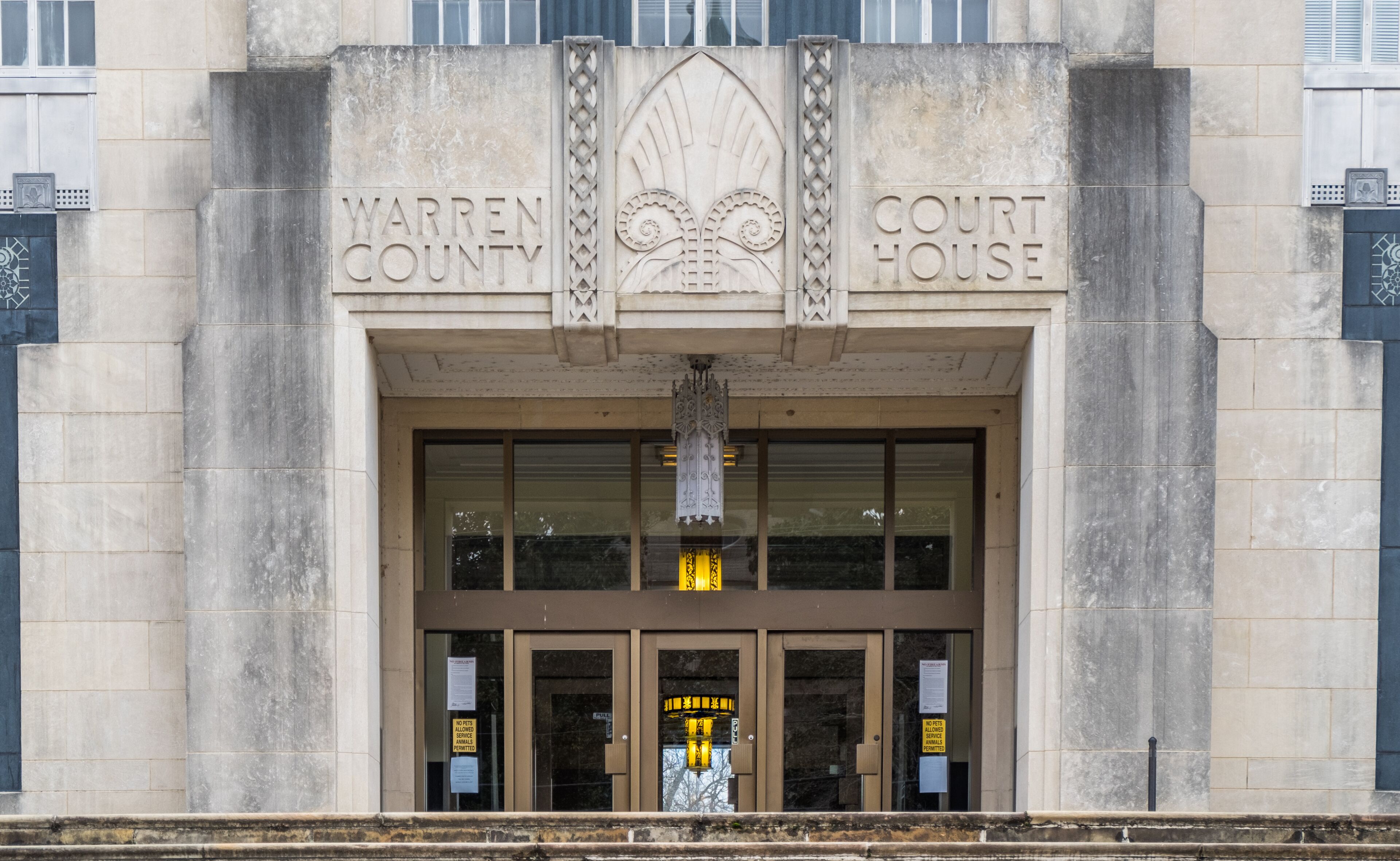 The entrance to the Warren County Court House with Gothic-style carvings and a large, ornate door.