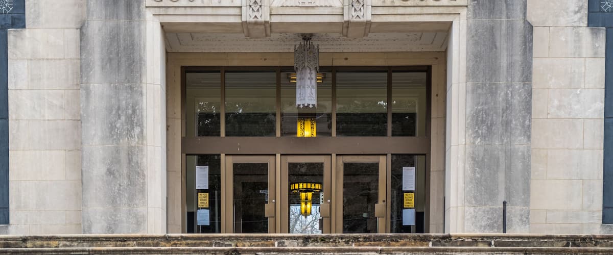 The entrance to the Warren County Court House with Gothic-style carvings and a large, ornate door.