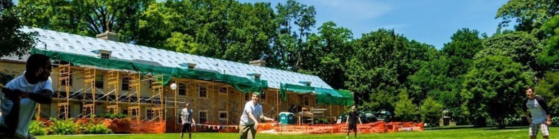 This College is amazingly open to the public people are strolling everywhere. There is a public pool, a nature walk and lots of old fashioned buildings. Feel free to come look around if you have kids bring bread for the duck pond. I'm here to be a camp counselor and we are playing whiffle ball.