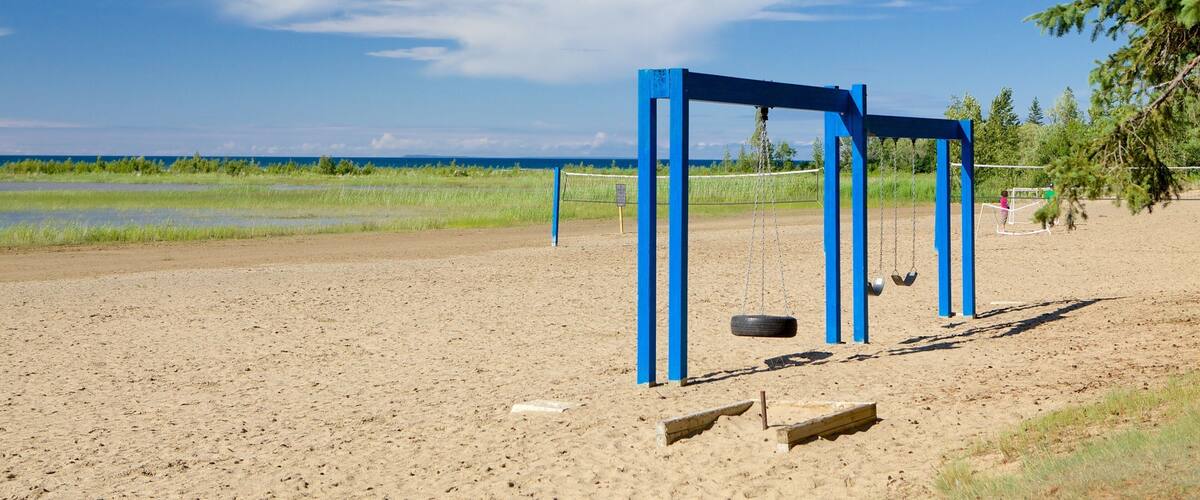 Blue Mountain Beach featuring a sandy beach and a playground