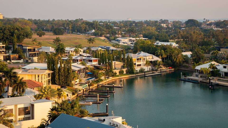 A residential area with houses, a marina, and a river.