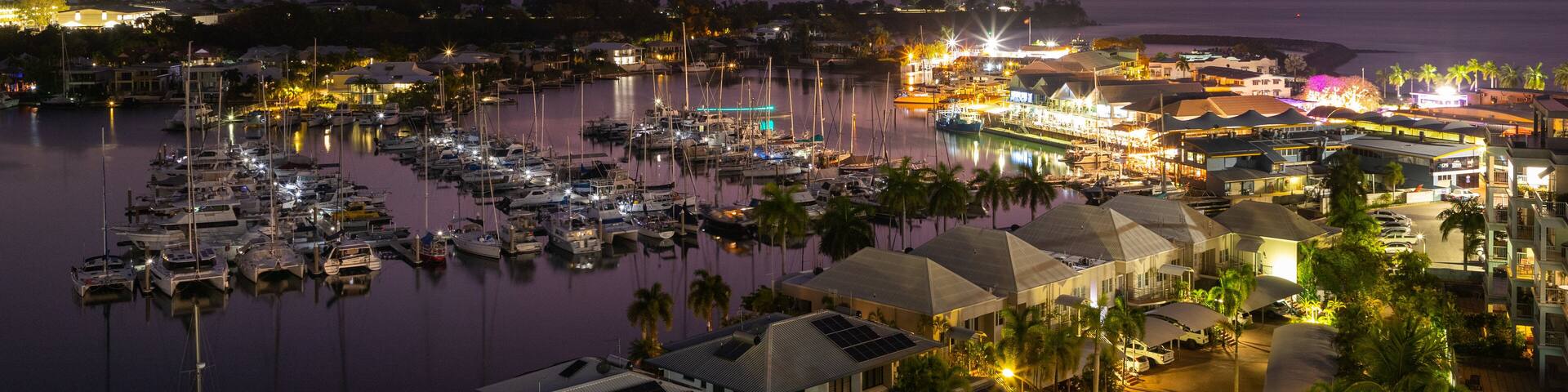 Cullen Bay Marina which includes a coastal town, a bay or harbor and night scenes
