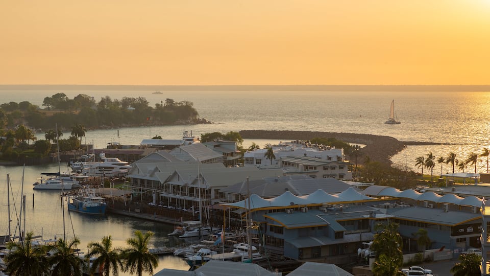 Cullen Bay Marina featuring a coastal town, landscape views and a sunset