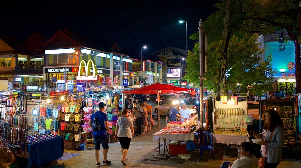 Chiang Mai Night Bazaar which includes night scenes, signage and street scenes