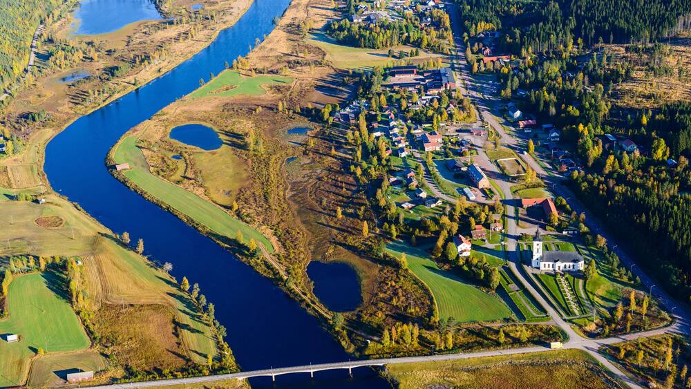 Aerial view of river and village in autumn landscape