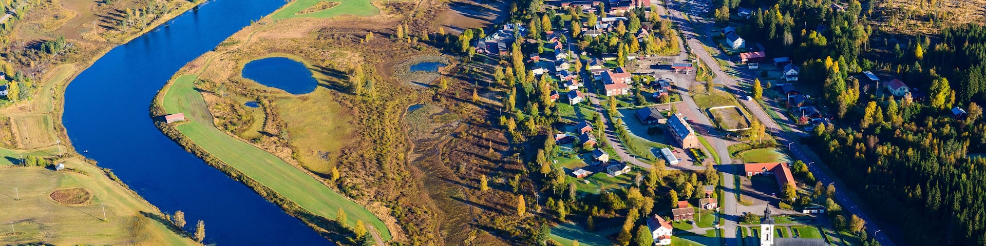 Aerial view of river and village in autumn landscape