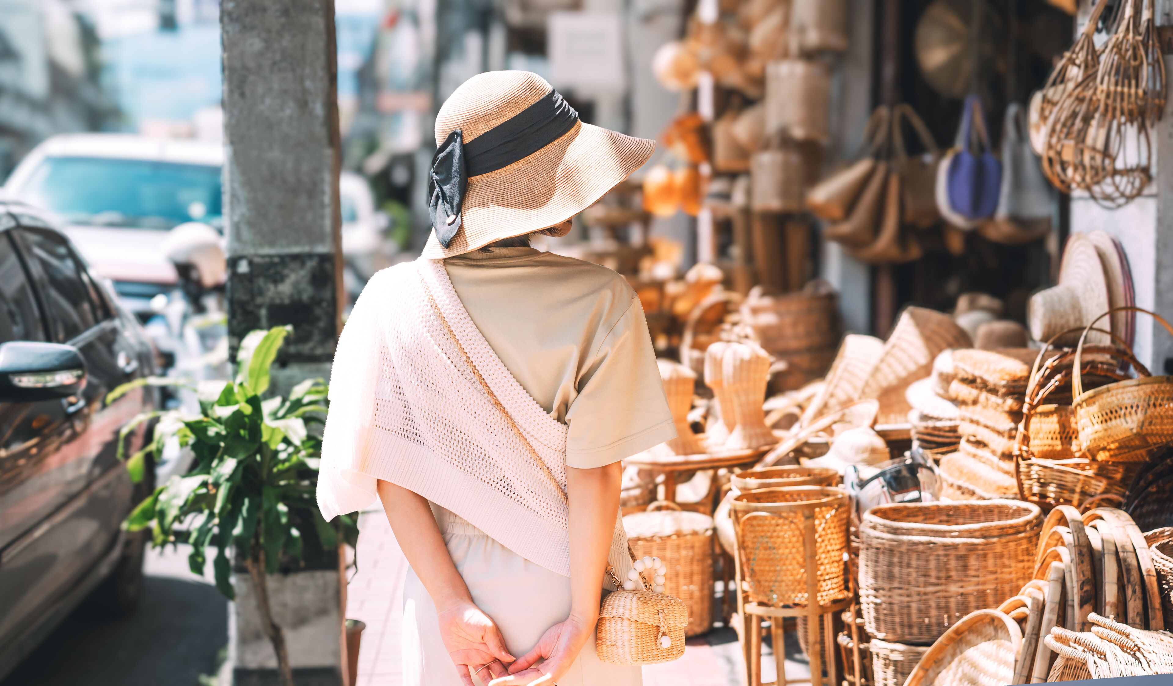 Behind traveler asian woman travel and shopping at wicker souvenir shop at local street Chiang Mai, Thailand