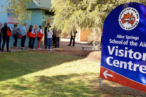 School of the Air welches beinhaltet Beschilderung sowie kleine Menschengruppe