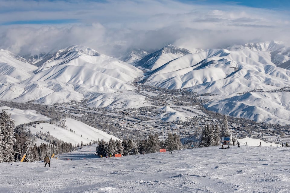 A snow-covered mountain range with a town nestled in the valley.