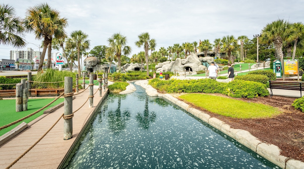 Captain Hook\'s Adventure Golf showing golf and a pond as well as a couple