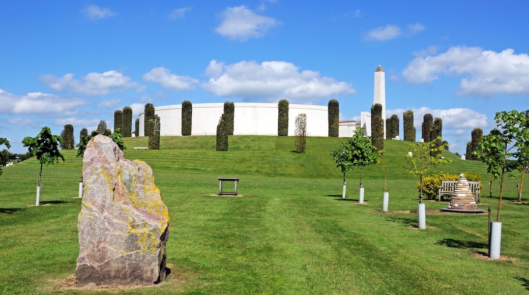 View of the Armed Forces Memorial with a large rock in the foreground, National Memorial Arboretum, Alrewas, UK.