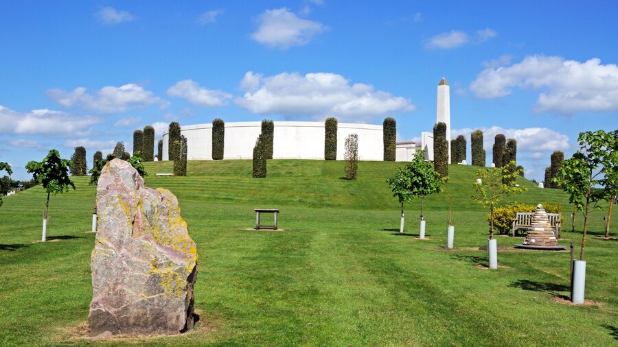 View of the Armed Forces Memorial with a large rock in the foreground, National Memorial Arboretum, Alrewas, UK.