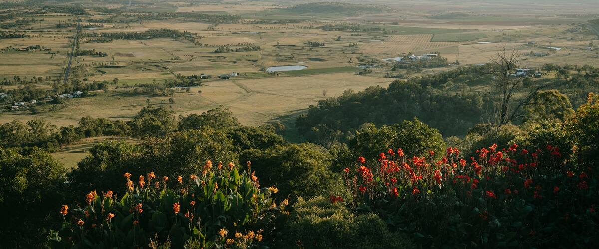 A rural landscape with fields, a lake, and scattered houses.