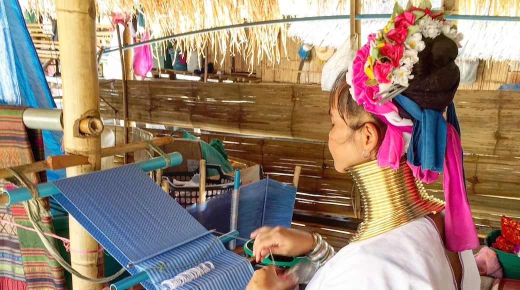 A woman of the Long Neck Karen Hill tribe weaving. These are a people from Myanmar living in Thailand. This photo taken with her consent.