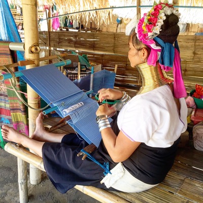 A woman of the Long Neck Karen Hill tribe weaving. These are a people from Myanmar living in Thailand. This photo taken with her consent.