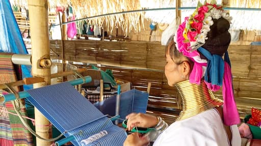A woman of the Long Neck Karen Hill tribe weaving. These are a people from Myanmar living in Thailand. This photo taken with her consent.