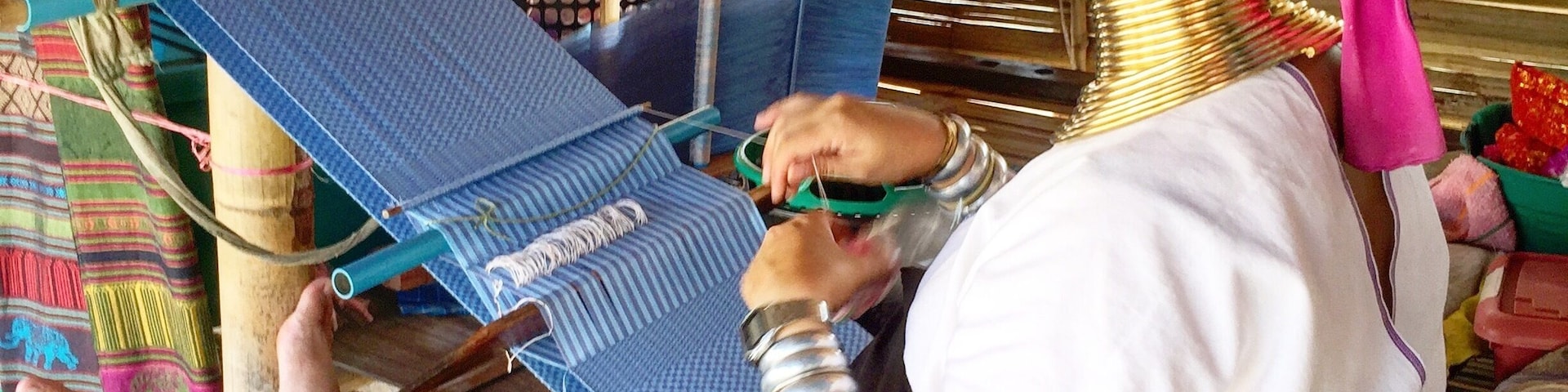 A woman of the Long Neck Karen Hill tribe weaving. These are a people from Myanmar living in Thailand. This photo taken with her consent.