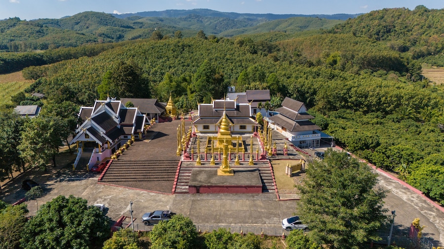 Aerial view of Buddhist pagoda named Wat Phra That Mok Mung Mueang located in Thoeng district of Chiang Rai province of Thailand.