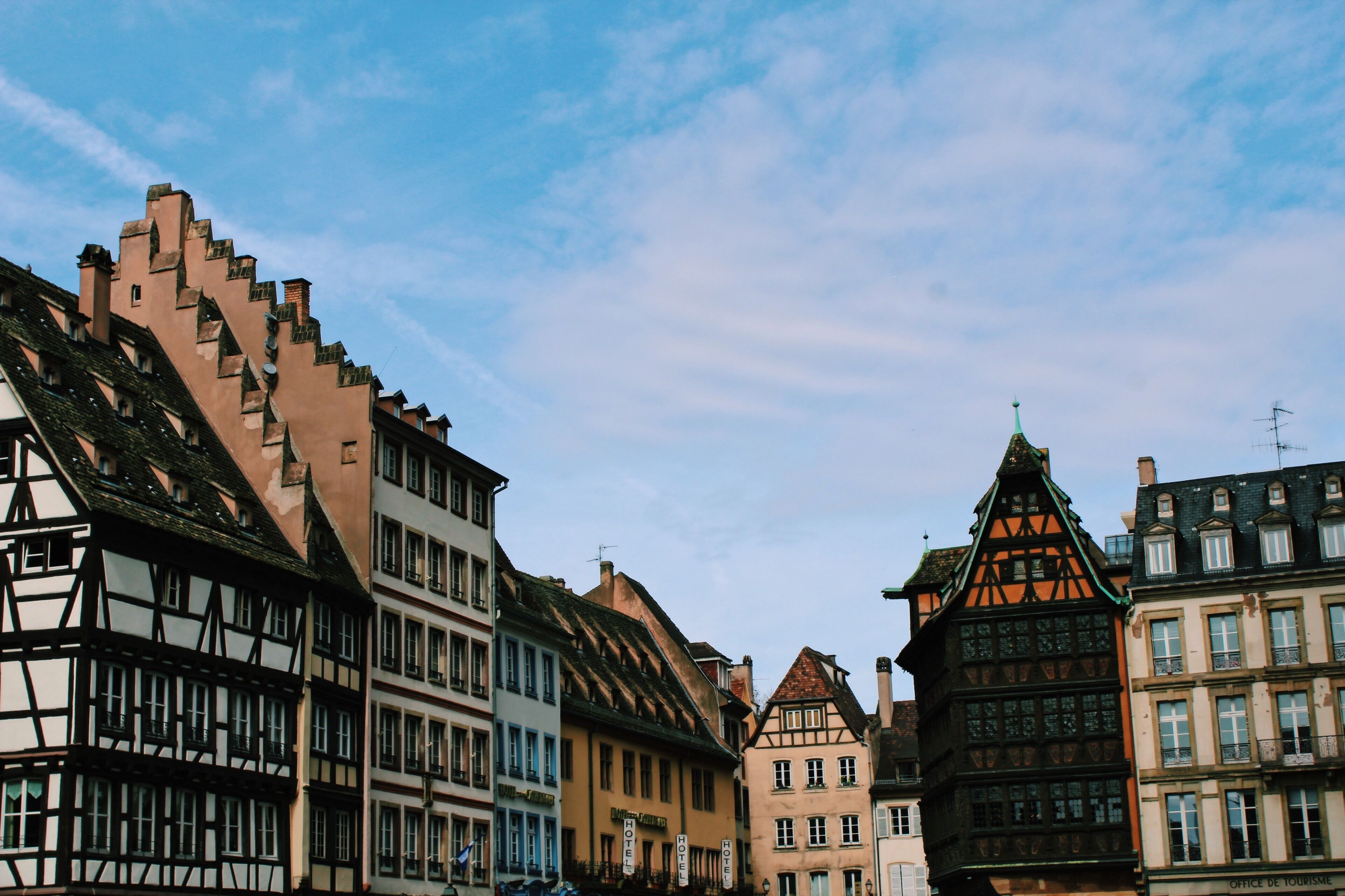 A street lined with historic half-timbered buildings under a clear sky.