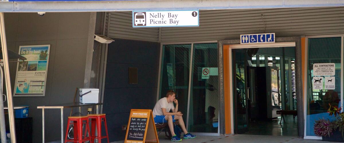 Magnetic Island Ferry Terminal featuring signage as well as an individual male