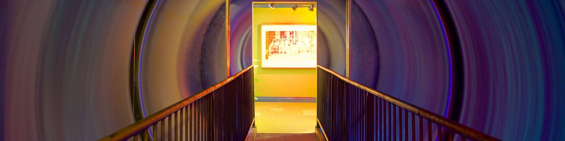 A spiral tunnel with a staircase leading to an exit.