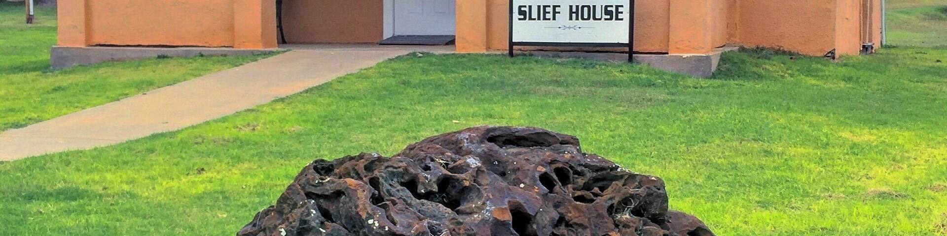 The old Minnie R. Slief Library, now in the City Park, Cheyenne, Oklahoma. The big rock in front is a 1,510 pound fossilized termite nest, at least 4 million years old.
