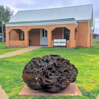 The old Minnie R. Slief Library, now in the City Park, Cheyenne, Oklahoma. The big rock in front is a 1,510 pound fossilized termite nest, at least 4 million years old.